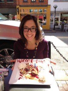 Holding a plate with a crepe, which reads "Happy Birthday"