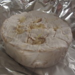 Brie stuffed with slices of garlic