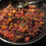 Cooked beans, peppers, onions, sausage, and diced tomatoes