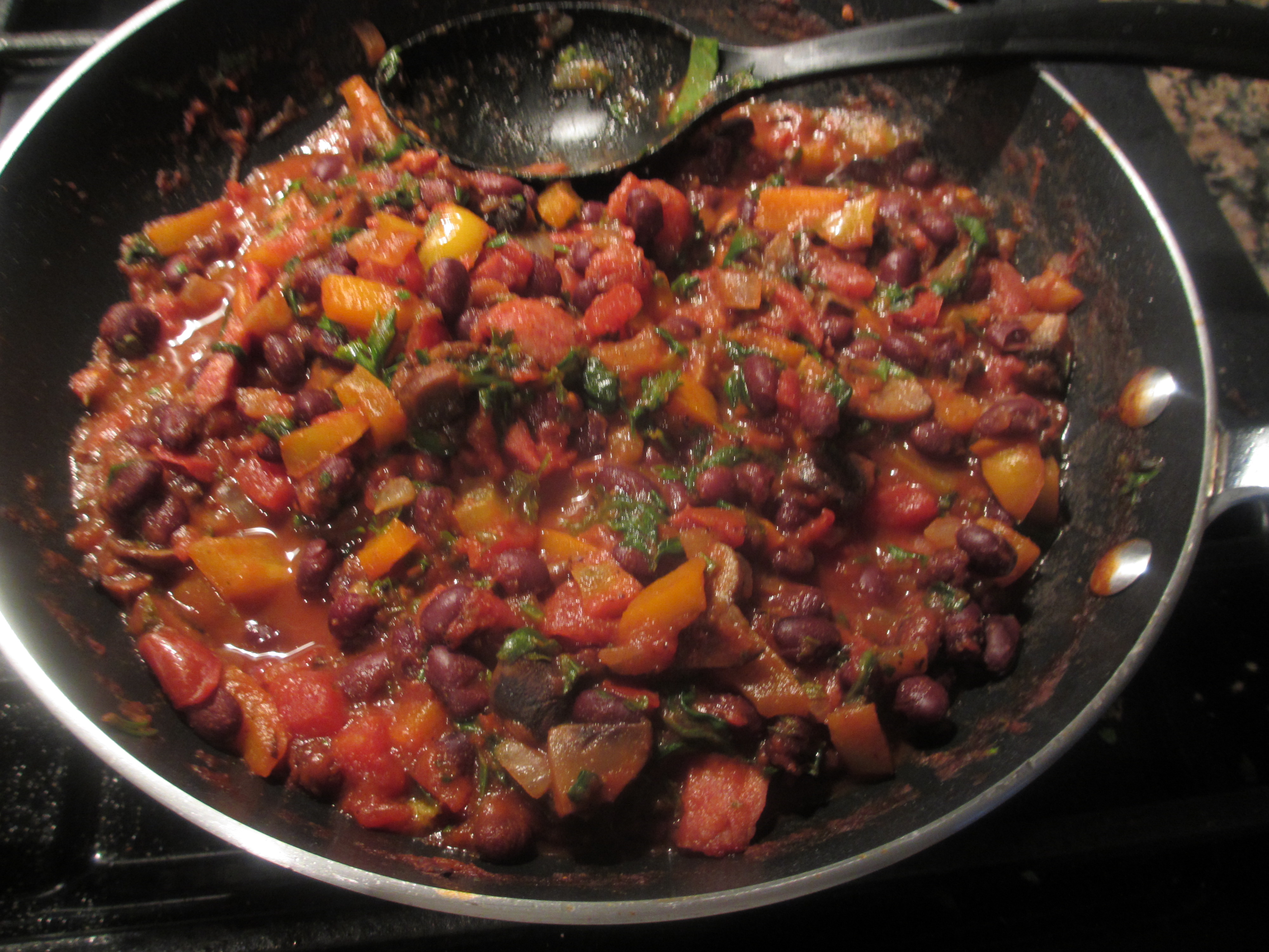 Cooked beans, peppers, onions, sausage, and diced tomatoes