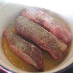 Beef short ribs cooking in oil