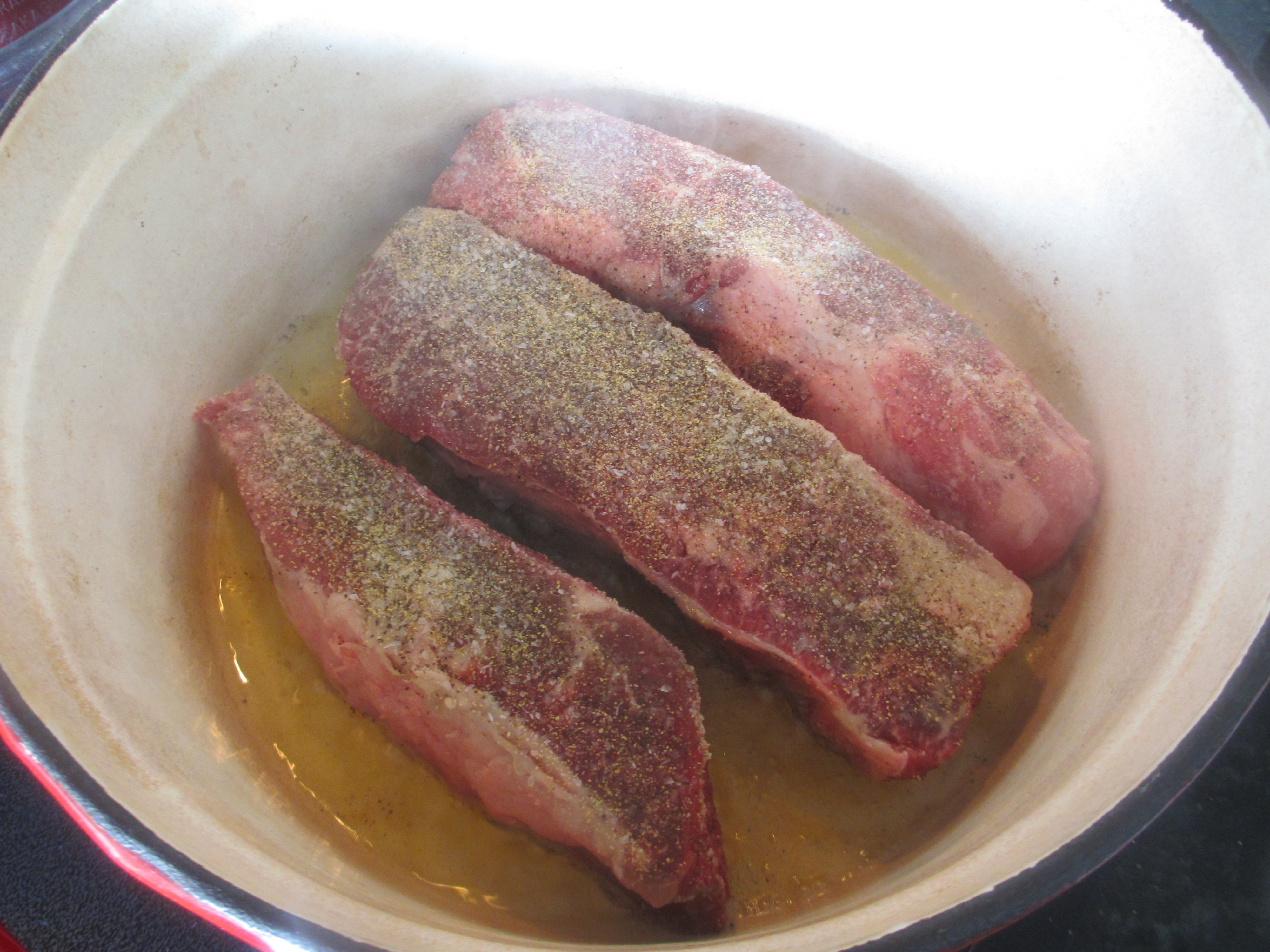 Beef short ribs cooking in oil