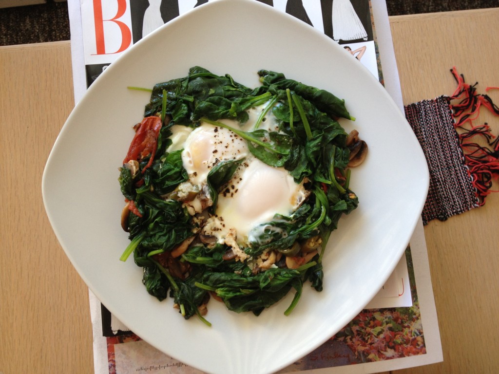 Two sunny side up eggs in a bed of sauteed spinach