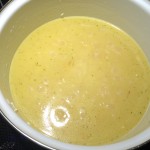 Rice in a pot with chicken broth