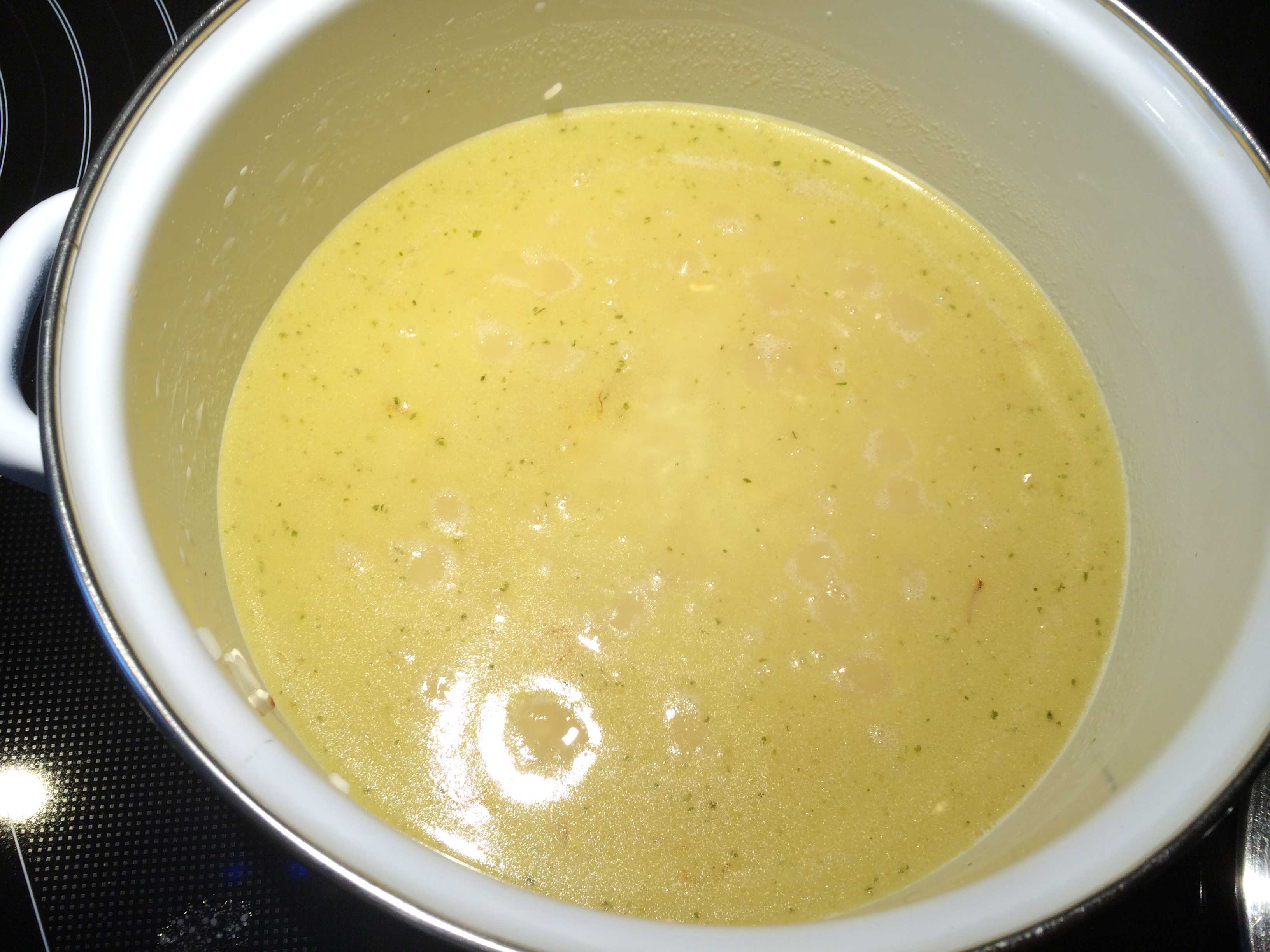 Rice in a pot with chicken broth