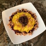 Plate of yellow rice with spiced beef, slivered almonds, and raisins