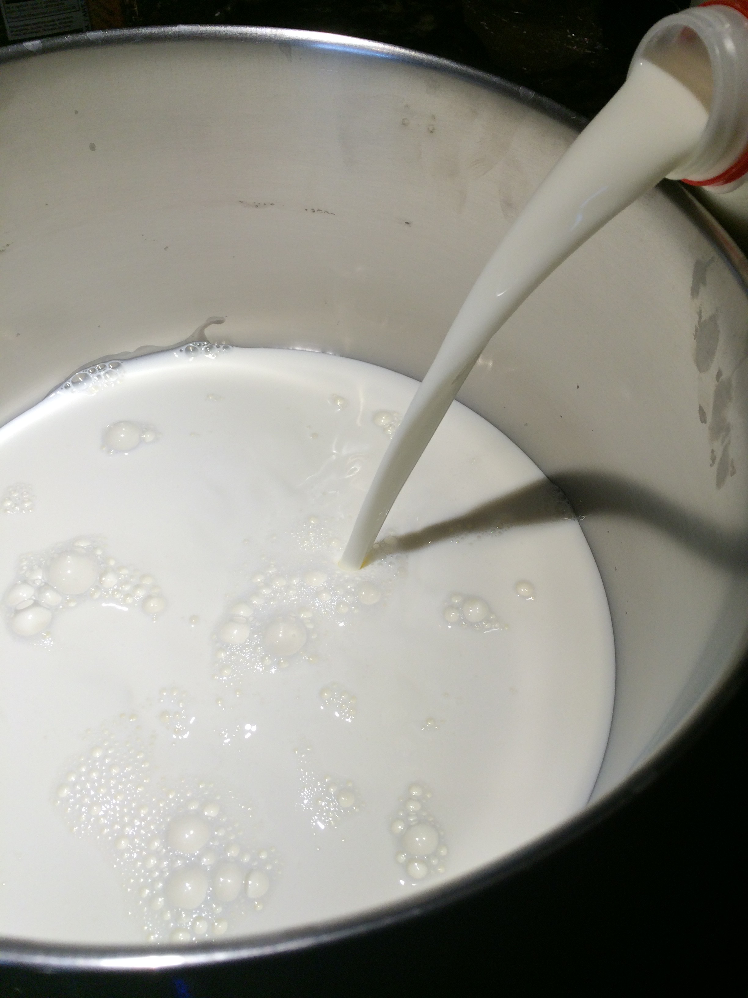 Milk being poured into a pot