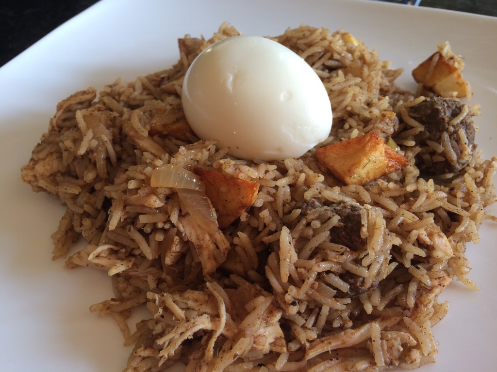Spiced rice with caramelized onions, potatoes, shredded chicken, and egg