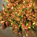 Coarse ground beef, mixed with parsley, spices, and onions