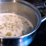 Butter boiling on the stove in a small stainless steel pot