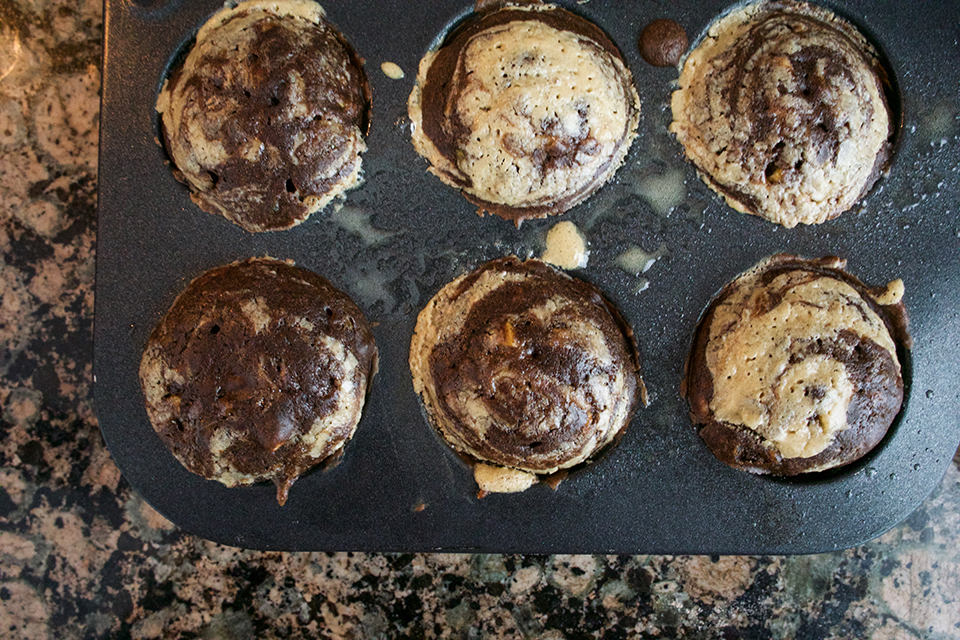 baked chocolate zucchini tahini muffins in muffin tins